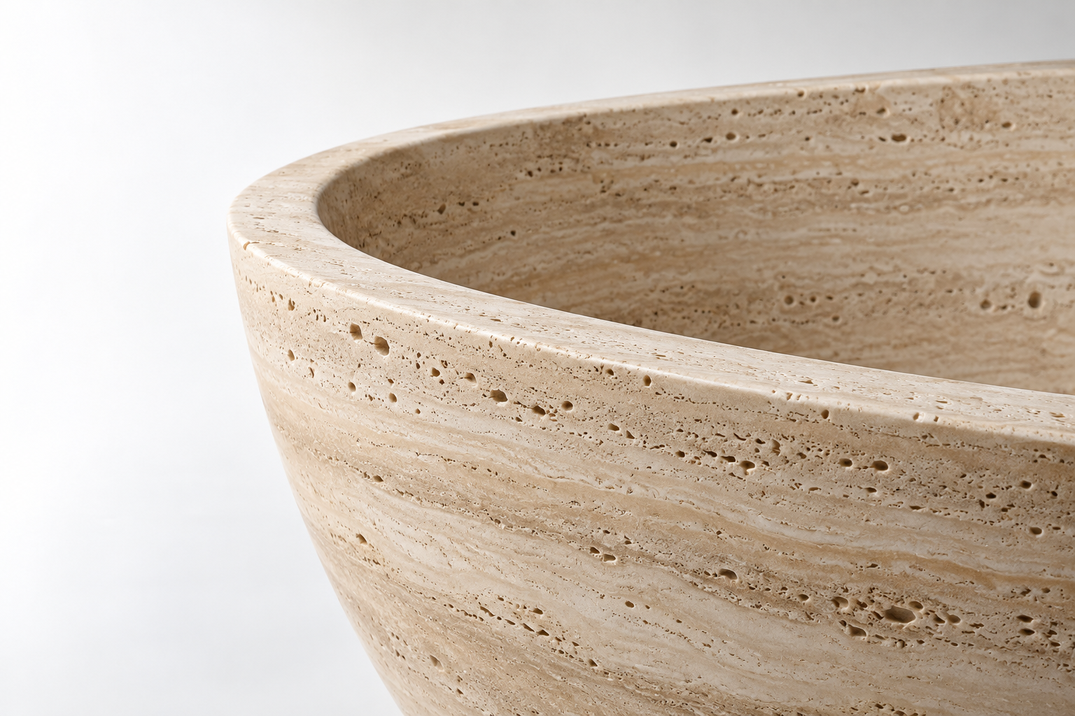 Close-up of a travertine bathtub rim — PREA bathroom collection