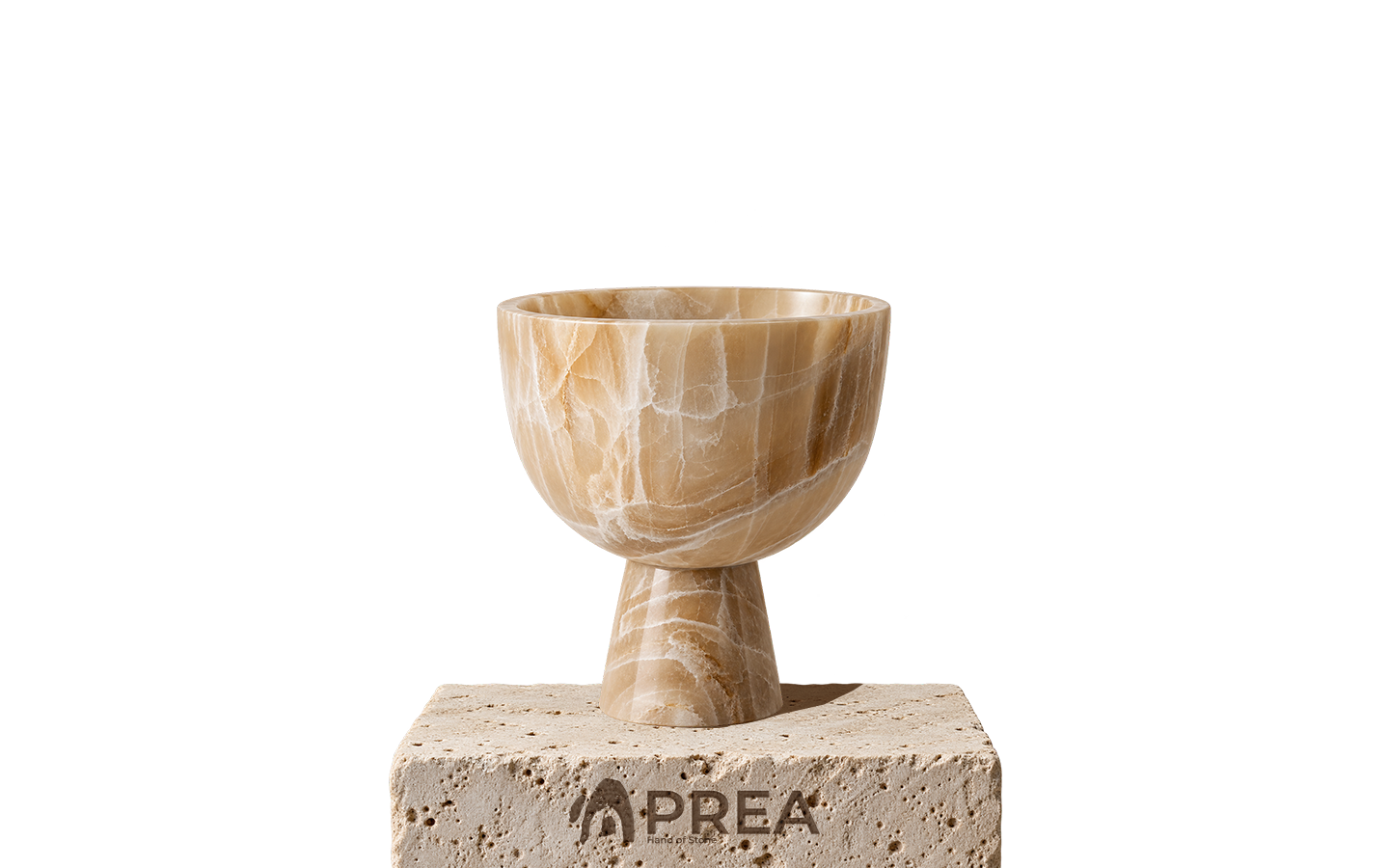Honey-coloured onyx bowl on a stone plinth bearing the PREA logo